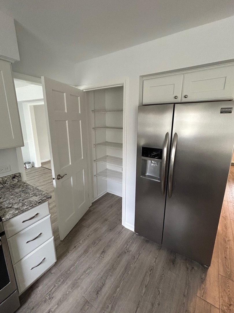 105 Golfview Circle Prospect Heights, IL 60070 - Photo 14 of 23 a view of a refrigerator in kitchen and an empty room
