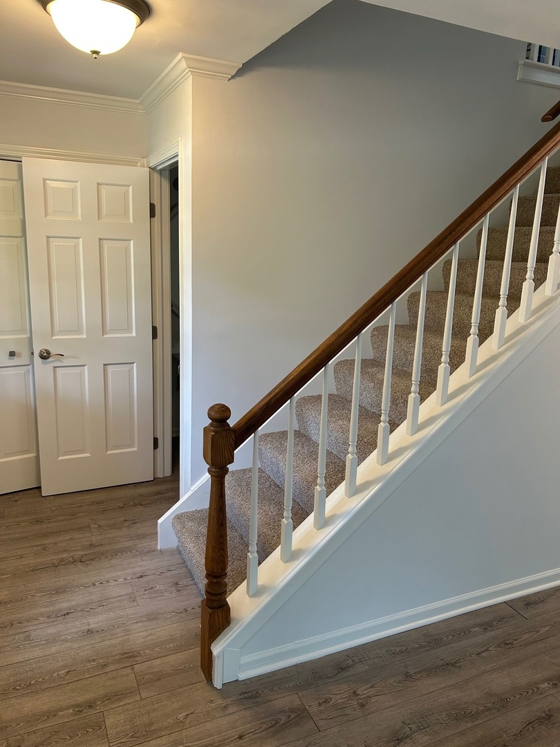 105 Golfview Circle Prospect Heights, IL 60070 - Photo 5 of 23 a view of a hallway with wooden floor and staircase