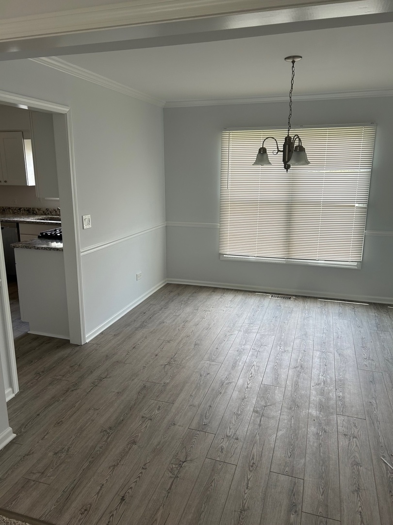 105 Golfview Circle Prospect Heights, IL 60070 - Photo 8 of 23 a view of a room with wooden floor and windows