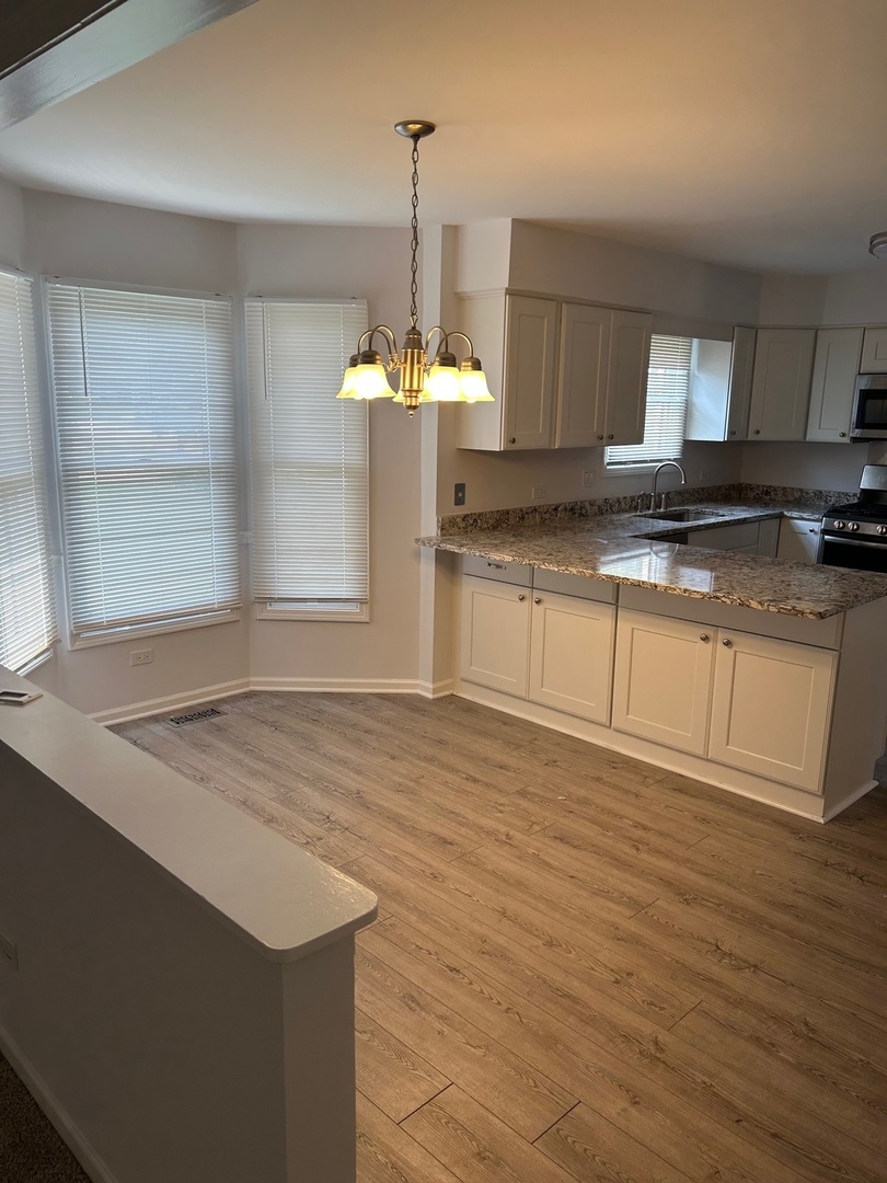 105 Golfview Circle Prospect Heights, IL 60070 - Photo 10 of 23 a kitchen with stainless steel appliances granite countertop a sink a stove a counter space and cabinets