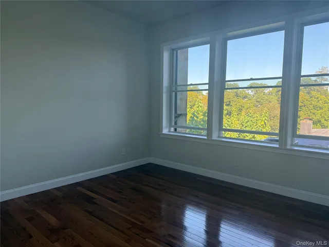 an empty room with wooden floor and closet
