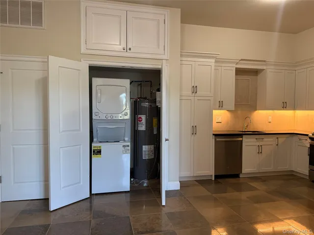 a kitchen with stainless steel appliances granite countertop a refrigerator and a stove