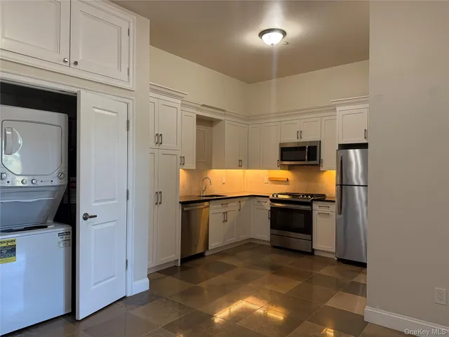 a kitchen with a sink and a refrigerator