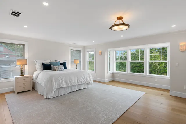 a spacious bedroom with a large bed and a large window