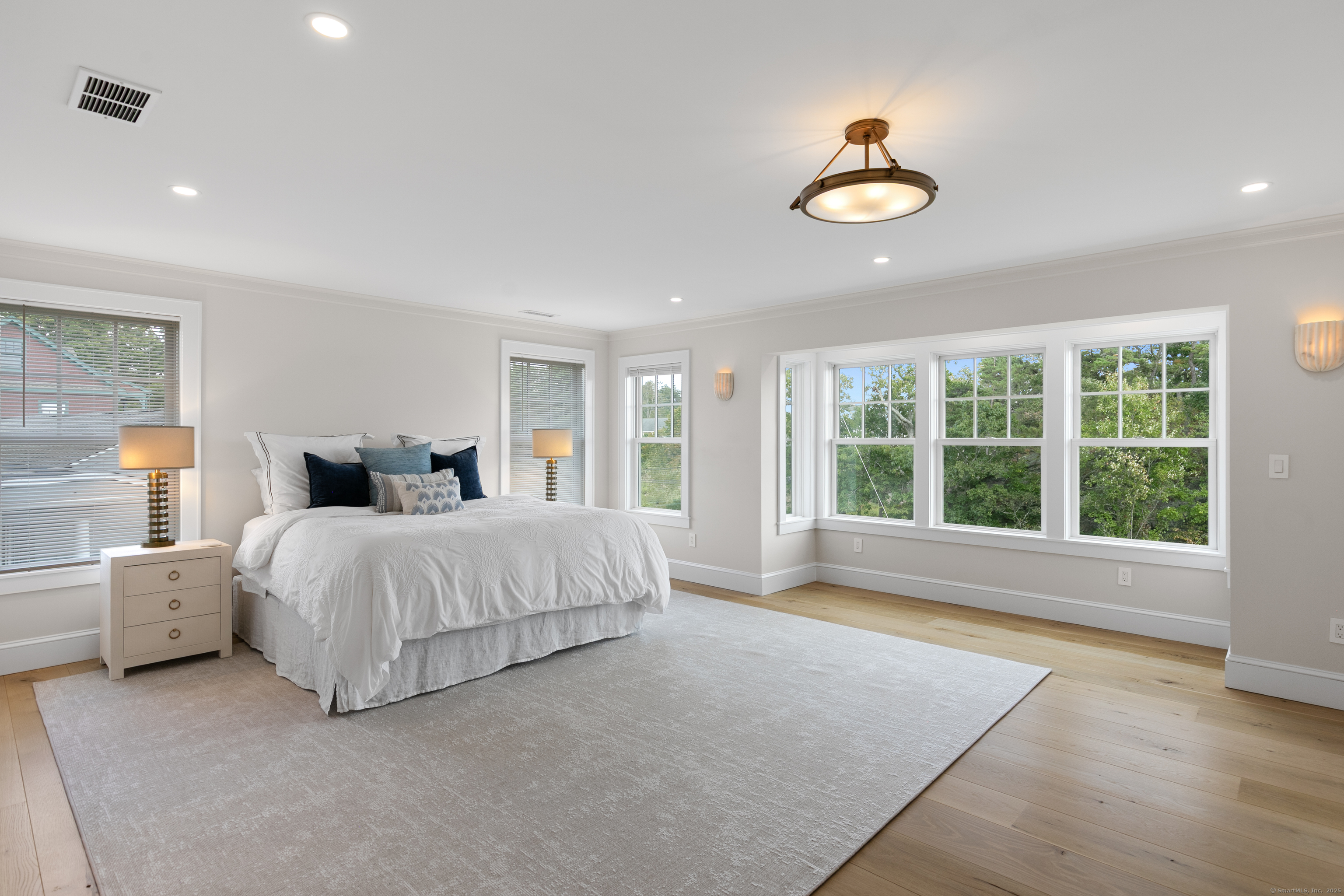 33 Thimble Farms Road Branford, CT 06405 - Photo 14 of 40 a spacious bedroom with a large bed and a large window