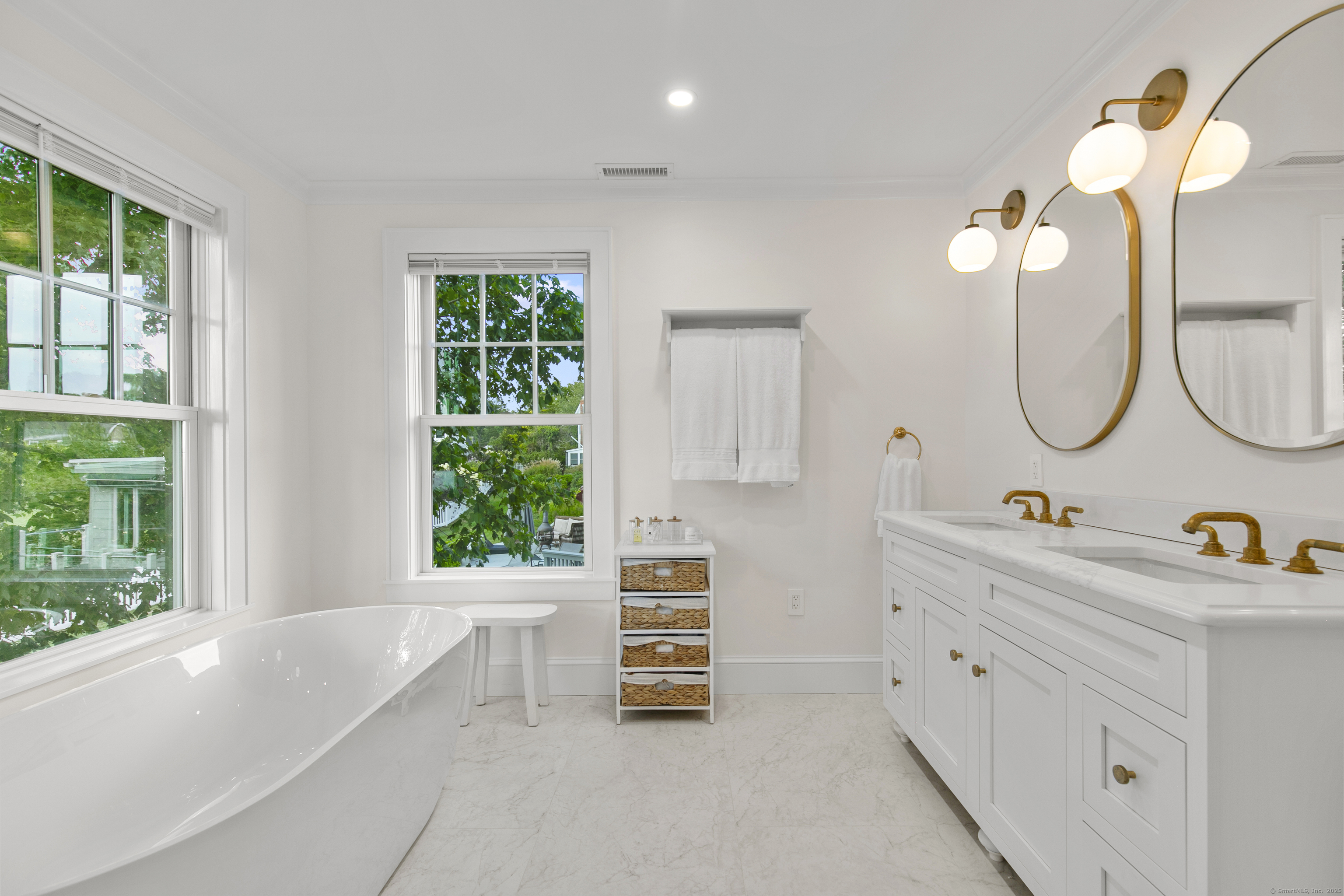 33 Thimble Farms Road Branford, CT 06405 - Photo 15 of 40 a bathroom with a double vanity sink a two mirror and a window