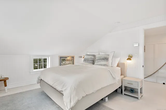 a bedroom with a bed and a lamp