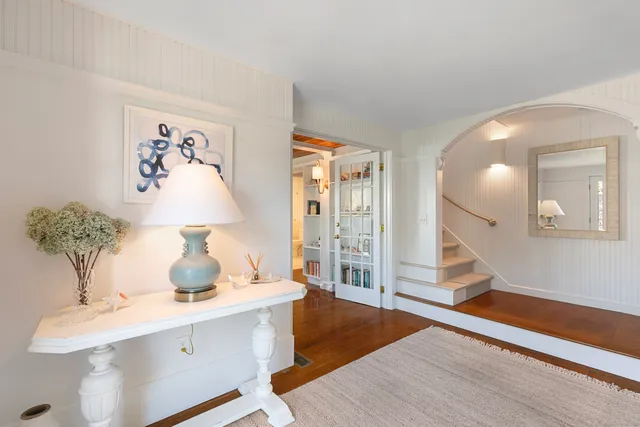 a view of a bedroom with wooden floor and cabinet