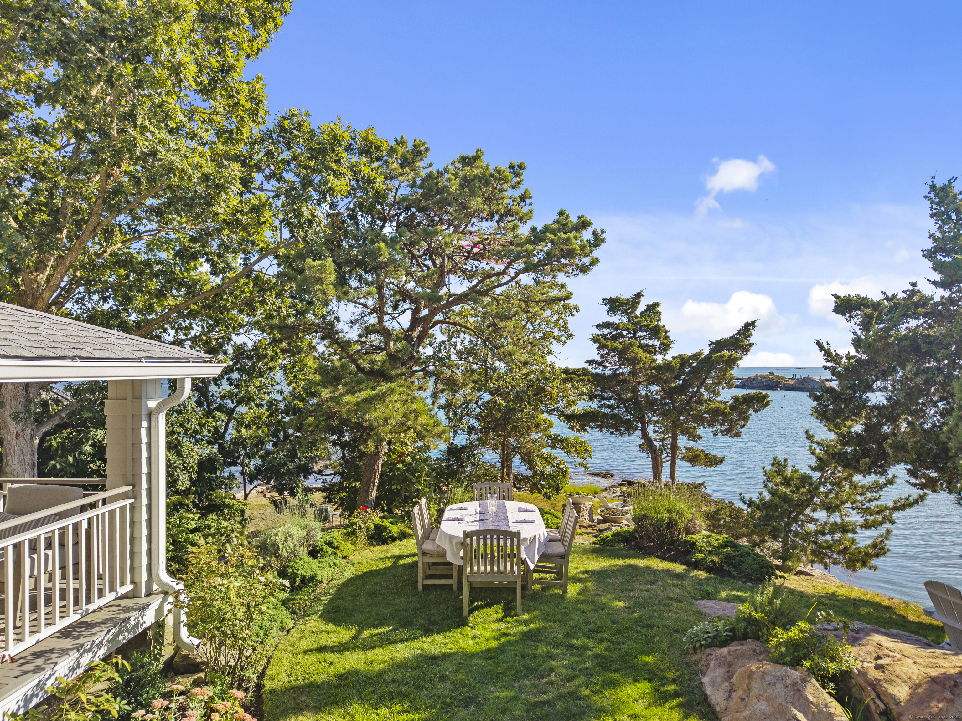 33 Thimble Farms Road Branford, CT 06405 - Photo 32 of 40 a backyard of a house with table and chairs