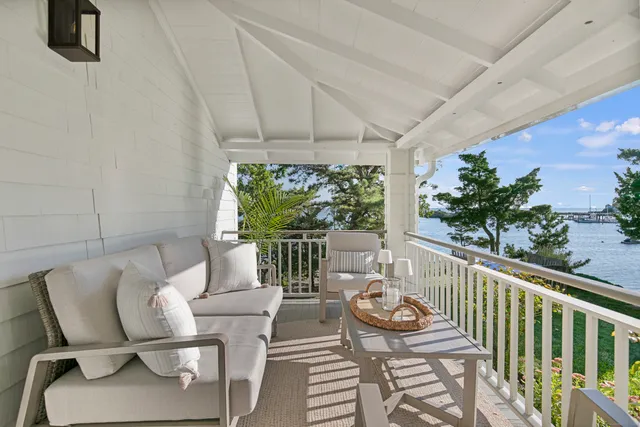 a balcony with furniture and potted plants