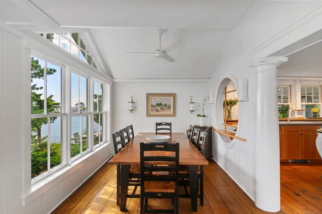 a view of a livingroom with furniture wooden floor windows and a chandelier