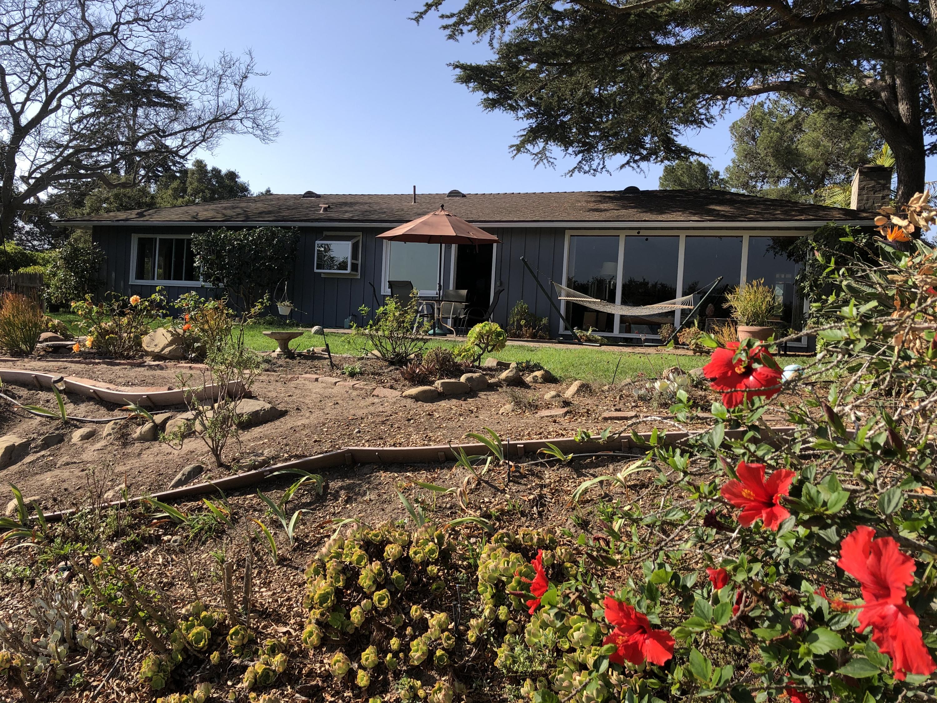 a front view of house with yard and seating space