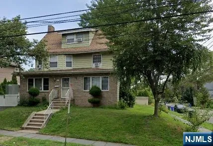 a view of a house with a yard and plants