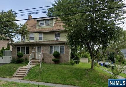 a view of a house with a yard and plants