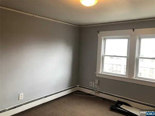 a room with a window and ceiling fan