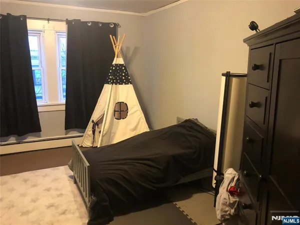 a view of bedroom with a sink and a mirror