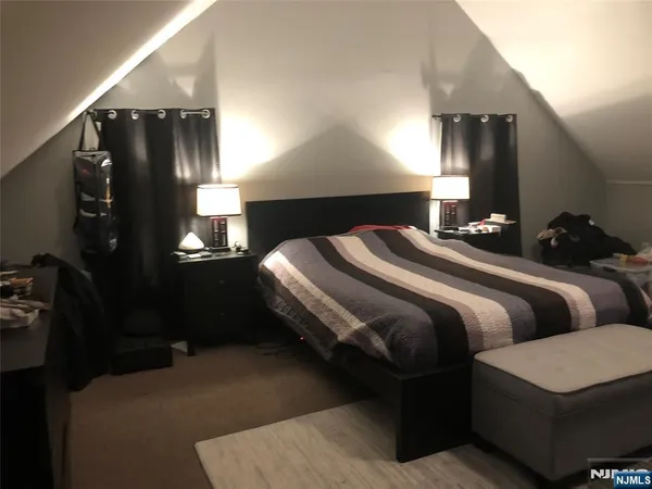 a bedroom with bed and mirror