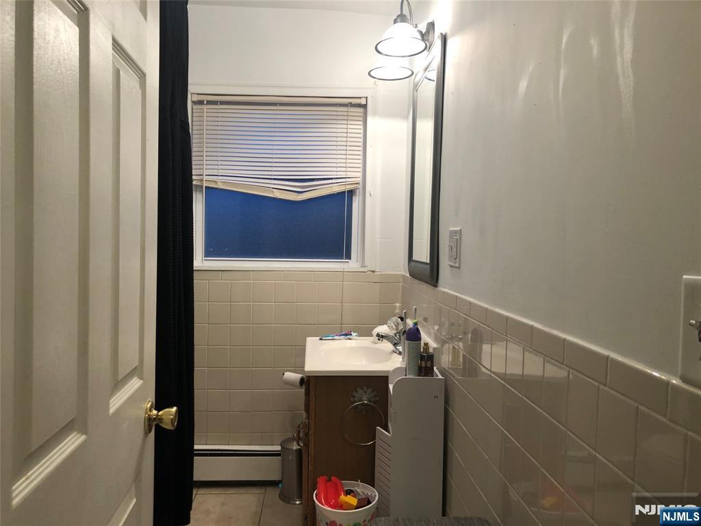 63 Highland Cross, Unit 2 Rutherford, NJ 07070 - Photo 18 of 19 a bathroom with a sink and mirror