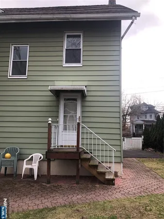 a view of a house with a yard and sitting area