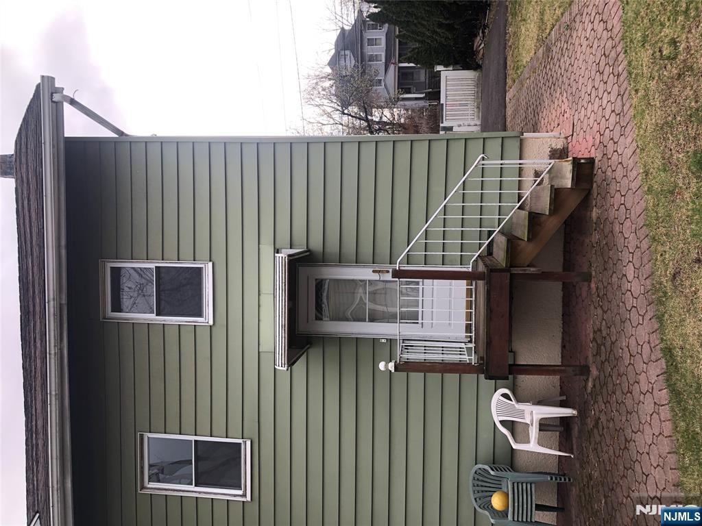 63 Highland Cross, Unit 2 Rutherford, NJ 07070 - Photo 19 of 19 a view of a house with a yard and sitting area