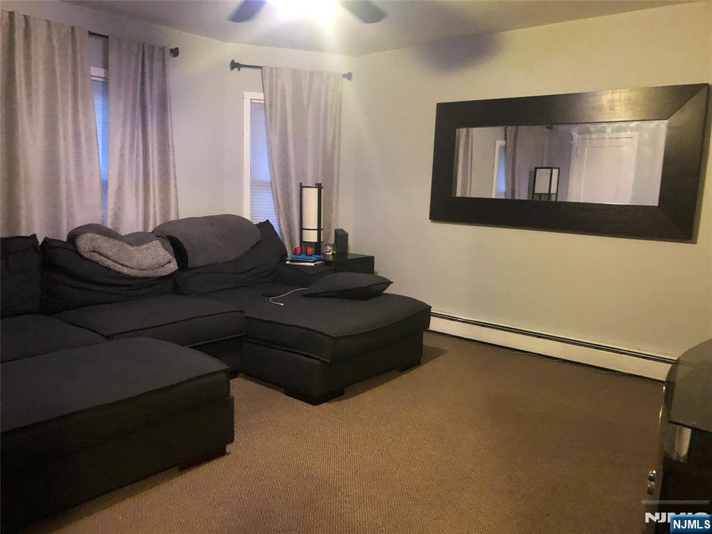 63 Highland Cross, Unit 2 Rutherford, NJ 07070 - Photo 3 of 19 a living room with furniture and a flat screen tv