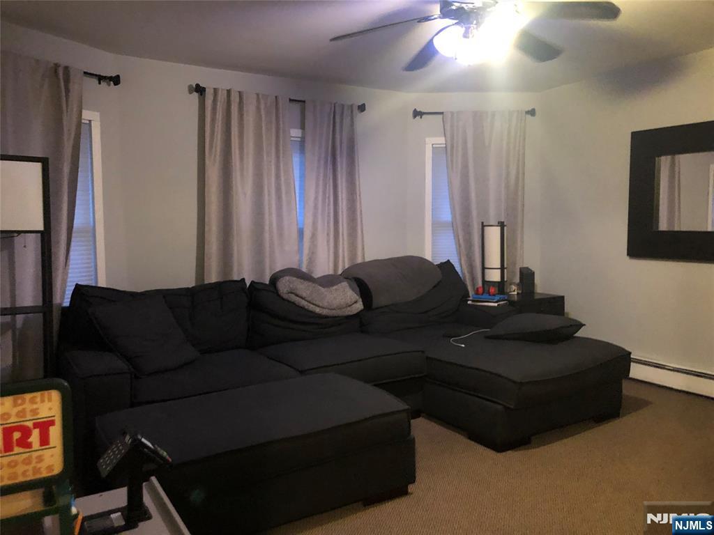 63 Highland Cross, Unit 2 Rutherford, NJ 07070 - Photo 4 of 19 a living room with furniture and a flat screen tv