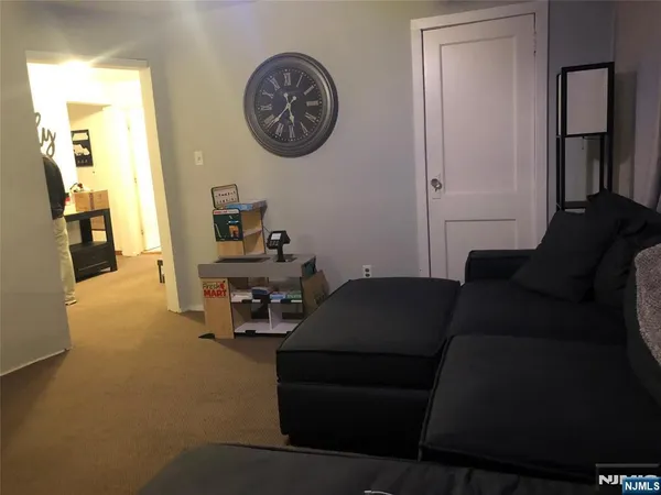 a living room with furniture and a mirror