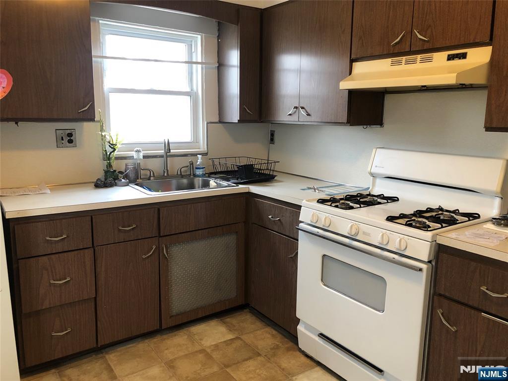 63 Highland Cross, Unit 2 Rutherford, NJ 07070 - Photo 6 of 19 a kitchen with a stove a sink and a window