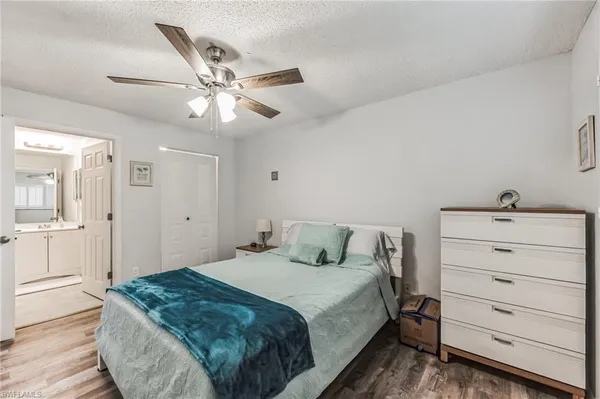 a bedroom with a bed and a ceiling fan