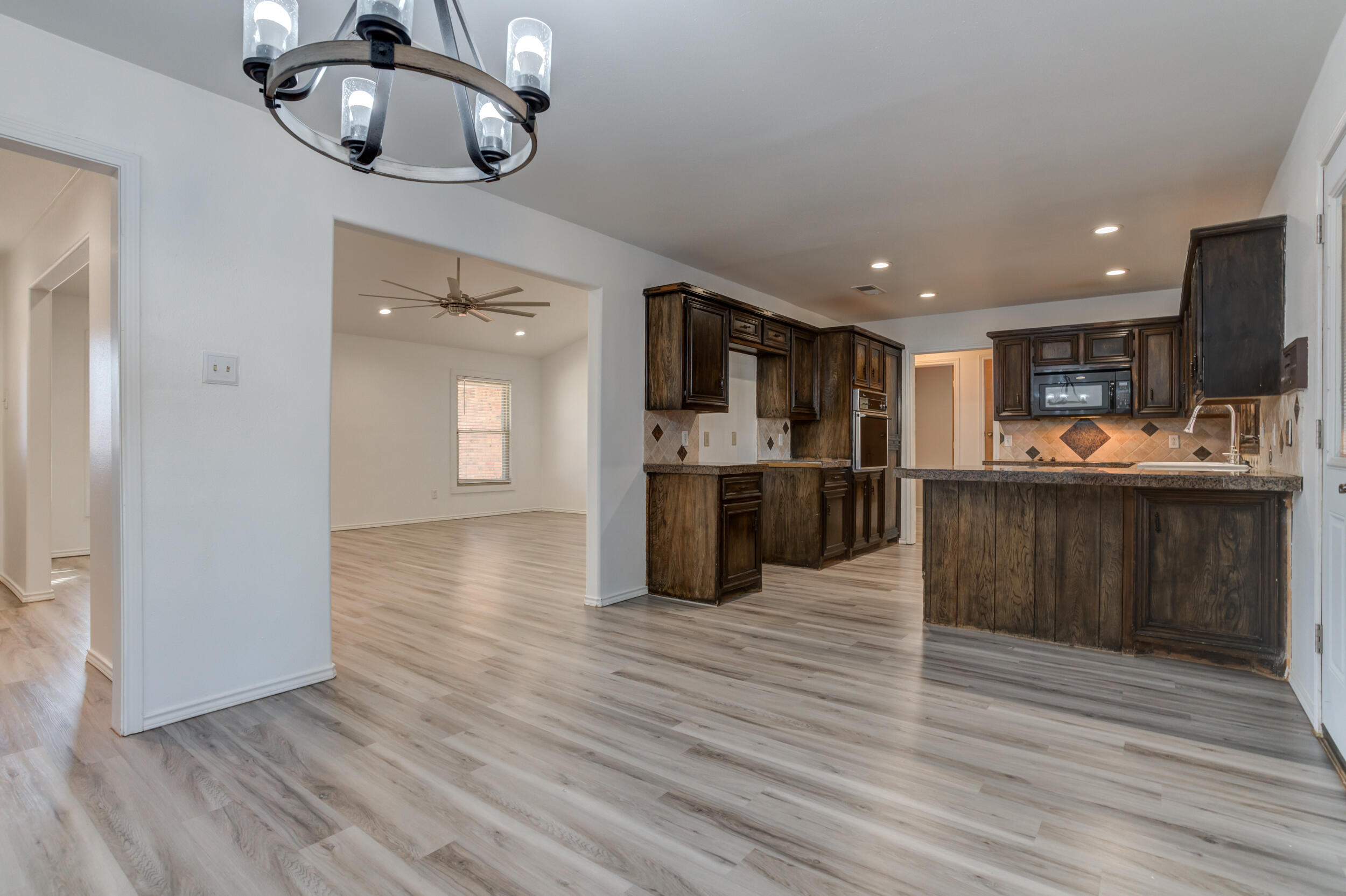 5504 73rd Street Lubbock, TX 79424 - Photo 13 of 39 a open kitchen with a sink and dishwasher a oven with wooden floor