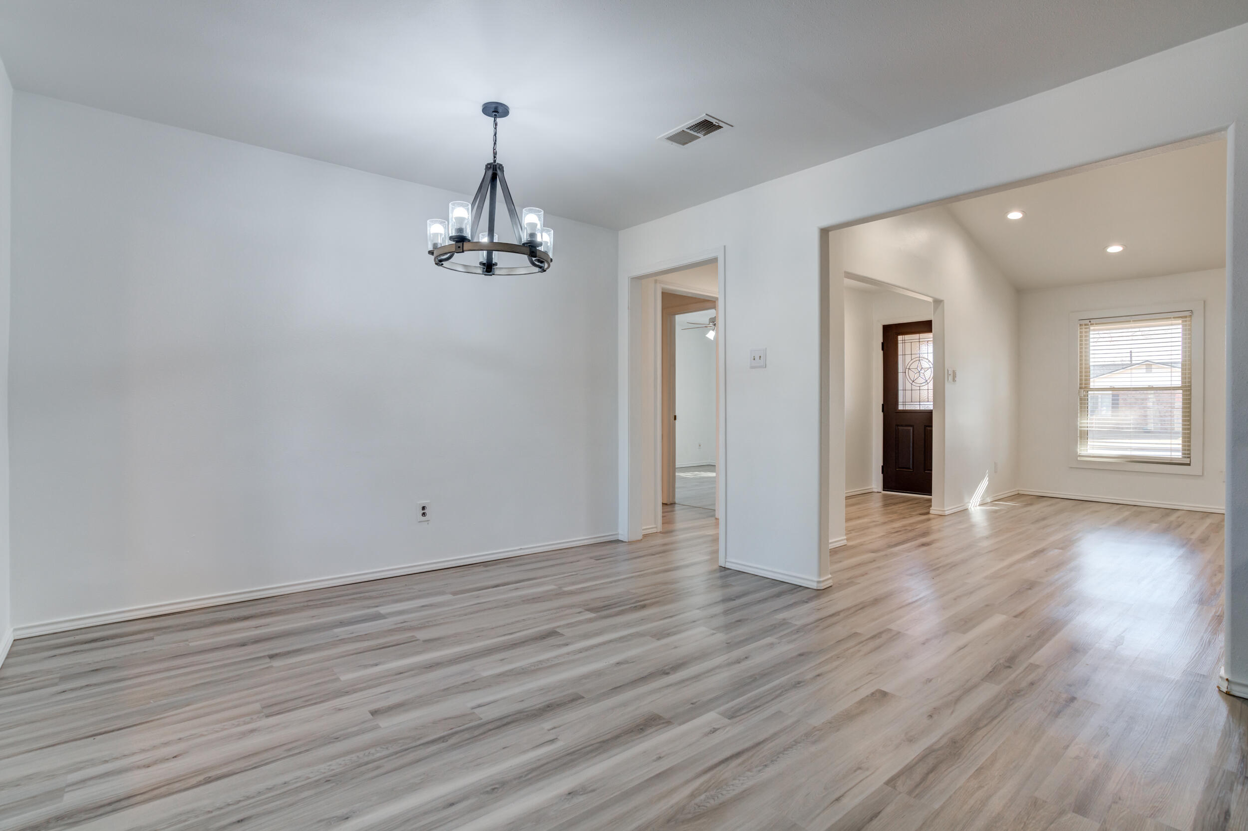5504 73rd Street Lubbock, TX 79424 - Photo 14 of 39 wooden floor in an empty room with a window