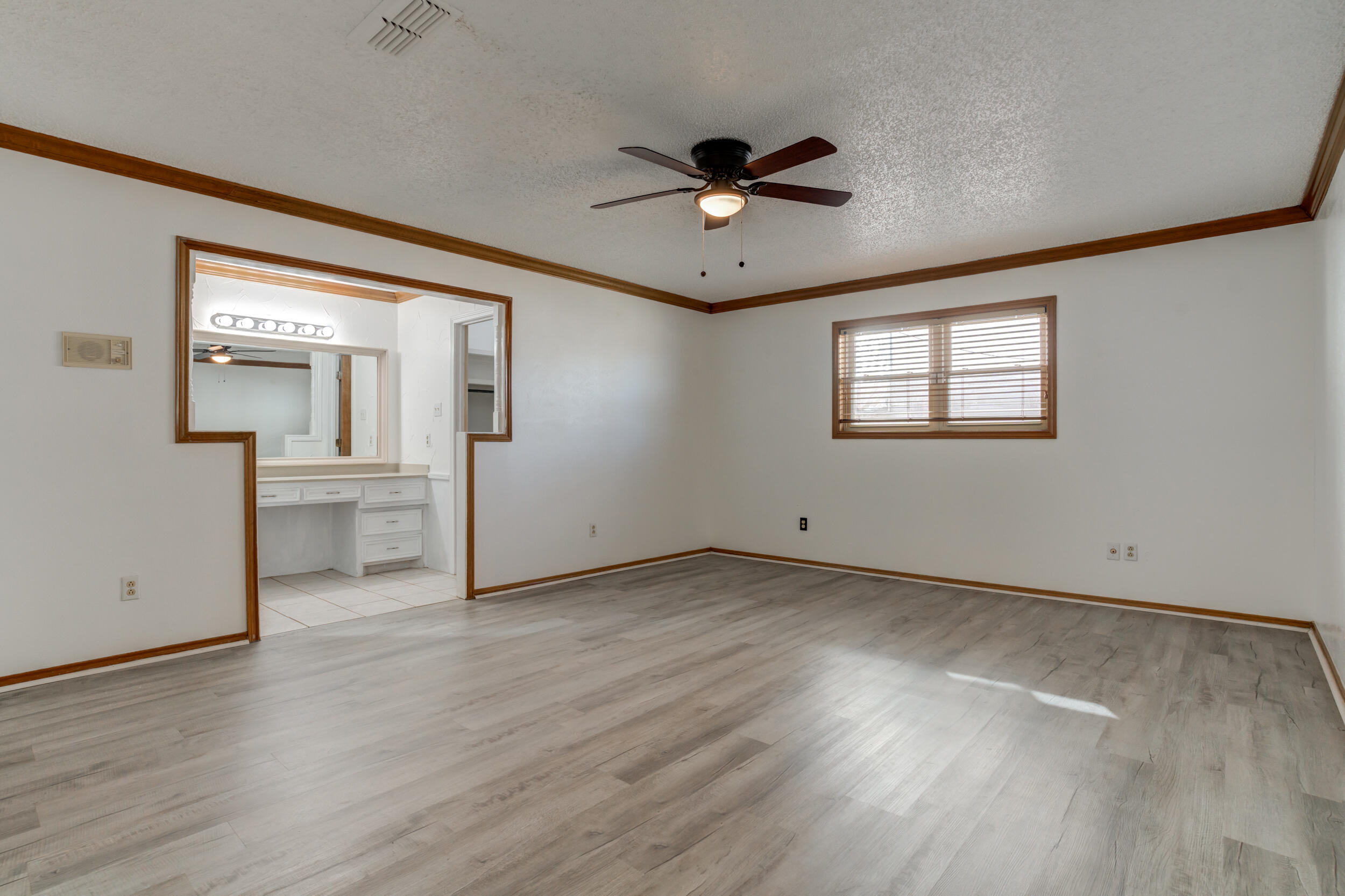 5504 73rd Street Lubbock, TX 79424 - Photo 24 of 39 wooden floor in an empty room with a window