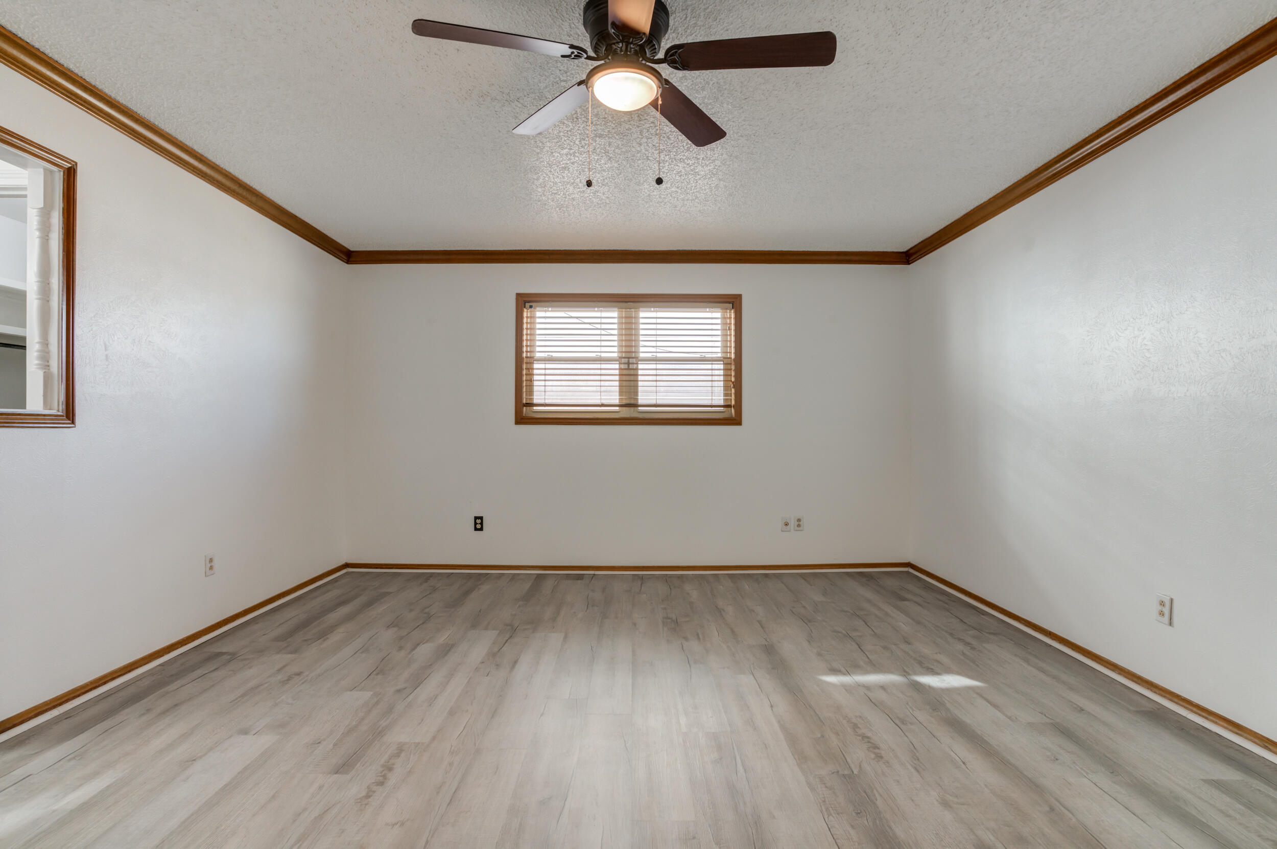 5504 73rd Street Lubbock, TX 79424 - Photo 25 of 39 an empty room with a window and a ceiling fan