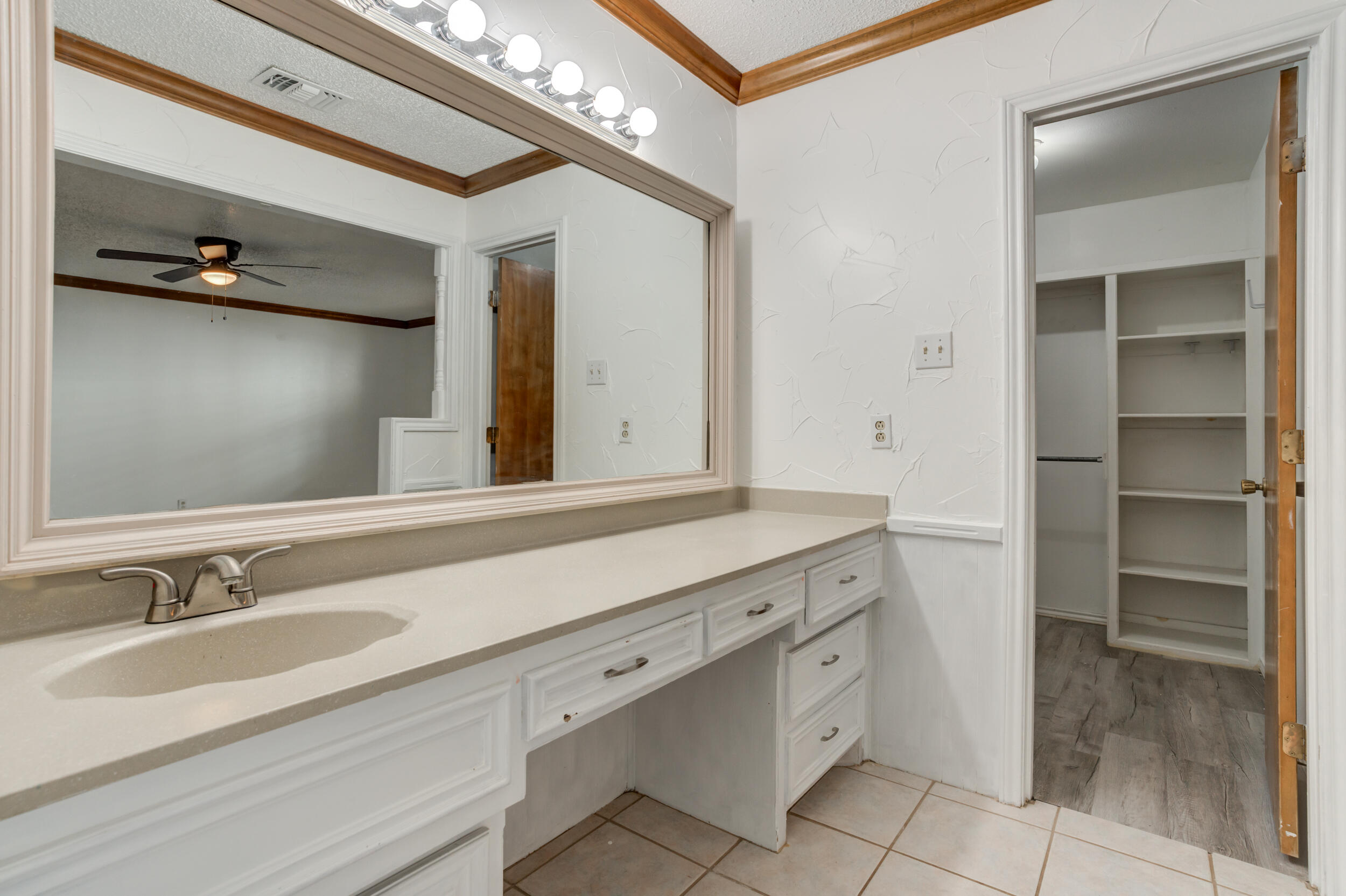 5504 73rd Street Lubbock, TX 79424 - Photo 27 of 39 a bathroom with a sink and a mirror