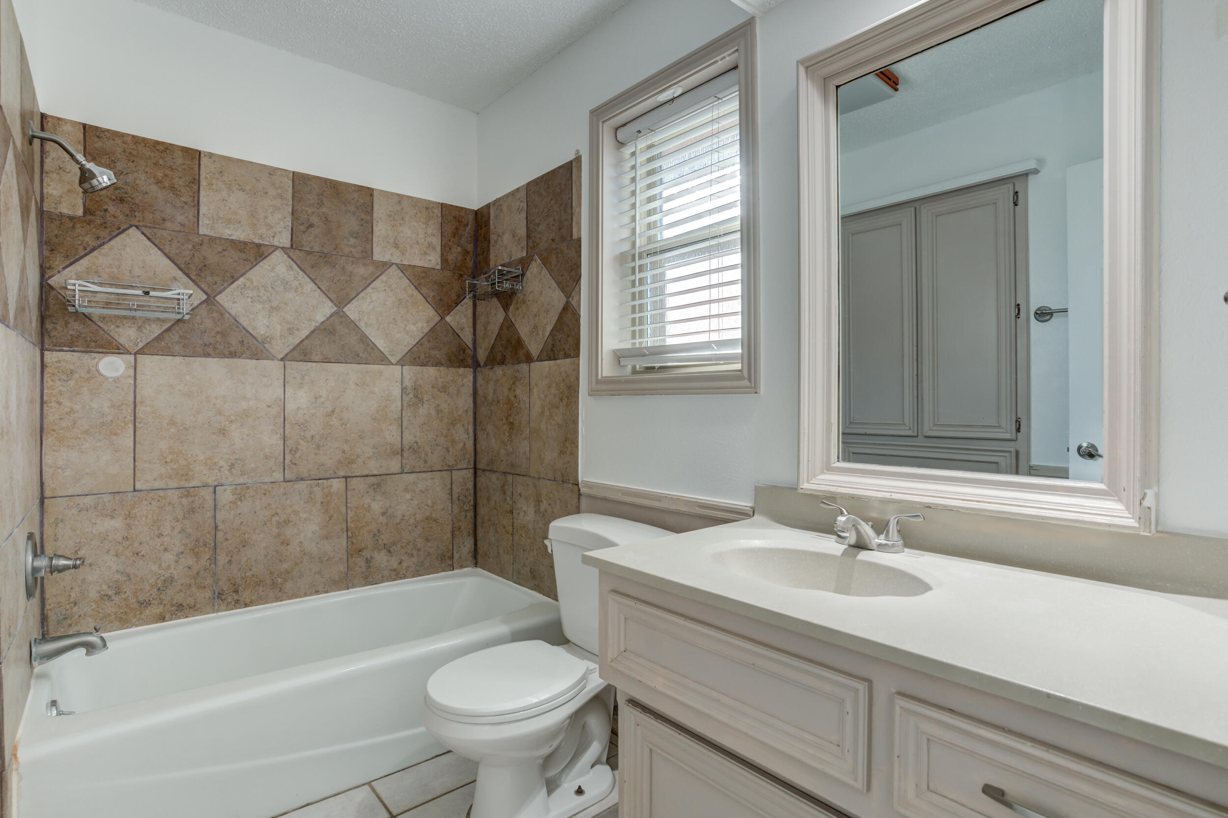 5504 73rd Street Lubbock, TX 79424 - Photo 29 of 39 a bathroom with a sink toilet and shower
