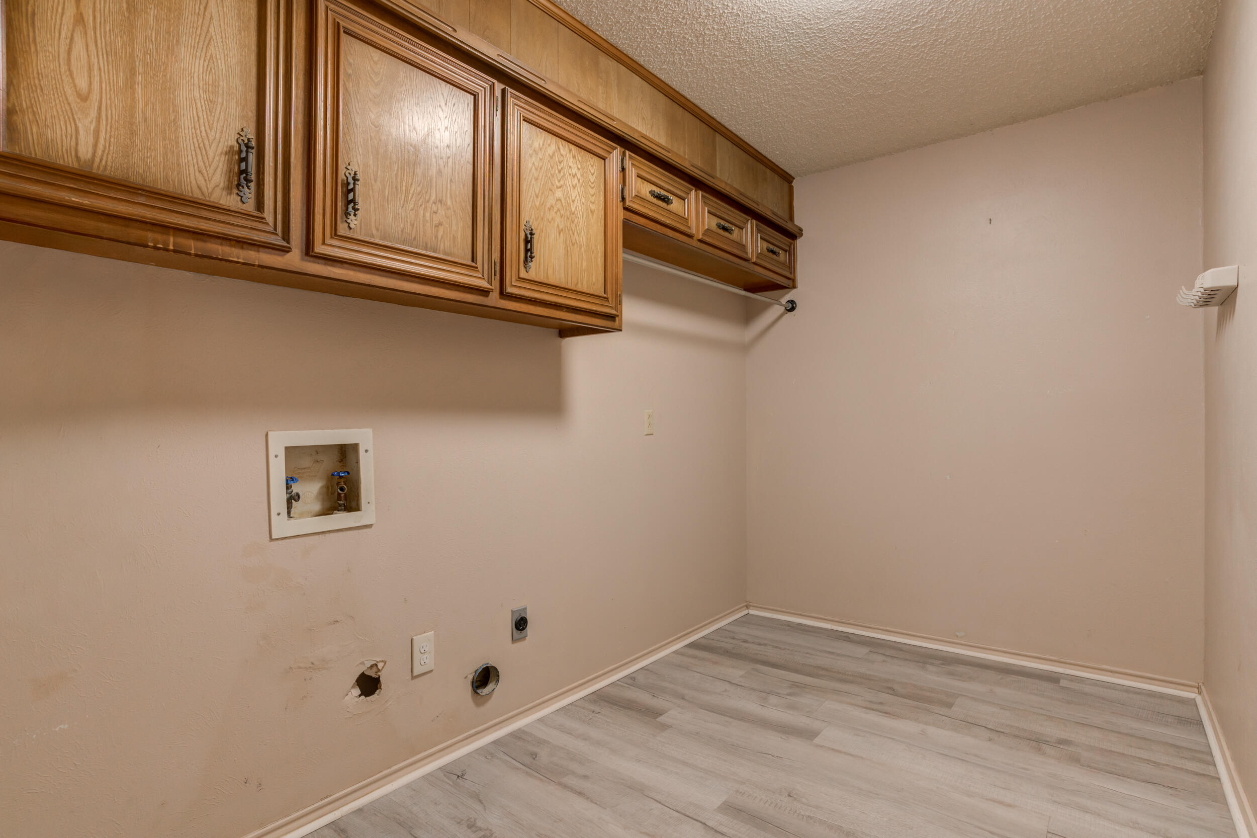 5504 73rd Street Lubbock, TX 79424 - Photo 30 of 39 a view of storage and utility room with wooden floor