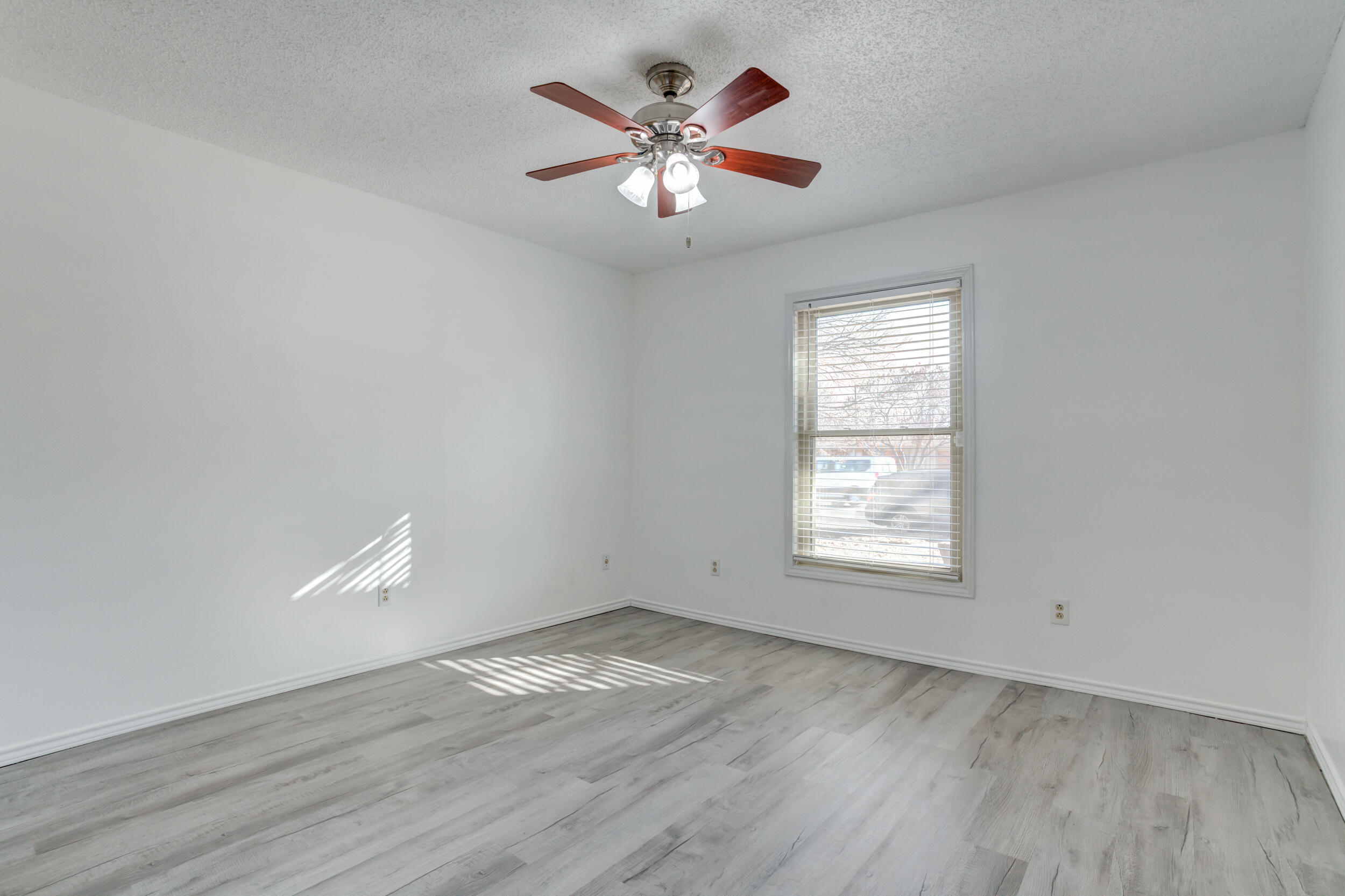 5504 73rd Street Lubbock, TX 79424 - Photo 31 of 39 an empty room with wooden floor and windows