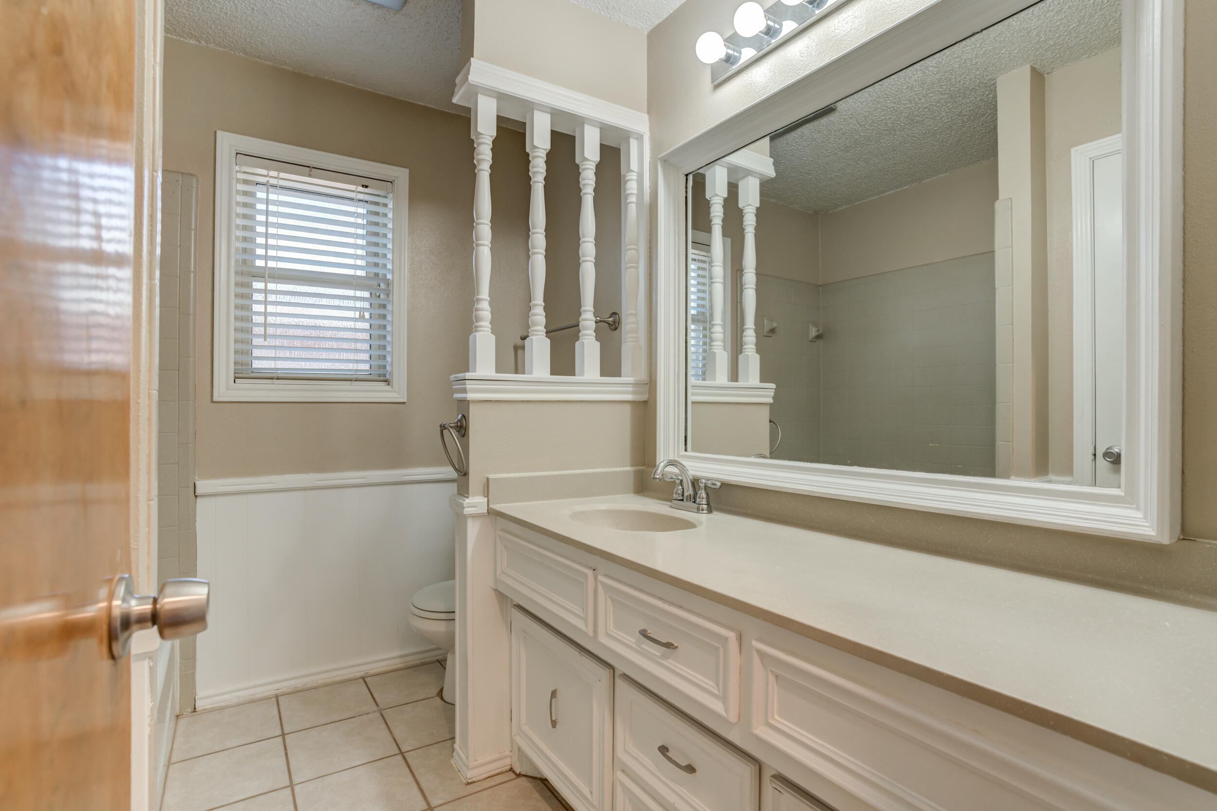 5504 73rd Street Lubbock, TX 79424 - Photo 32 of 39 a bathroom with a sink and a mirror