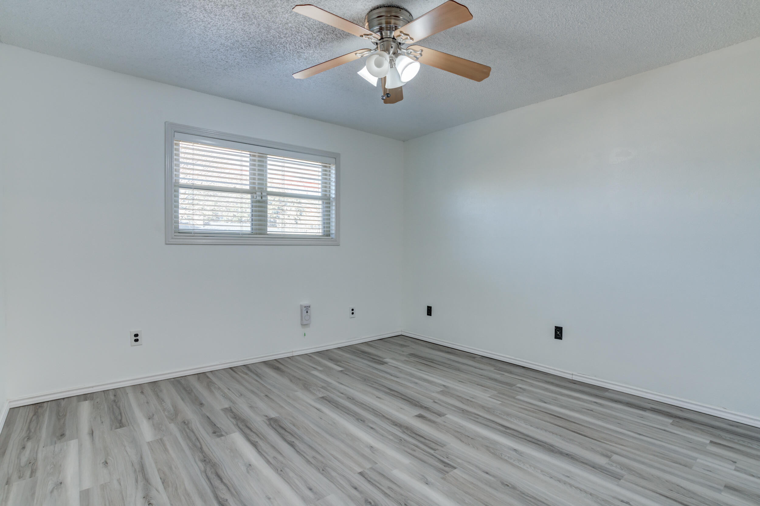 5504 73rd Street Lubbock, TX 79424 - Photo 34 of 39 wooden floor in an empty room with a window