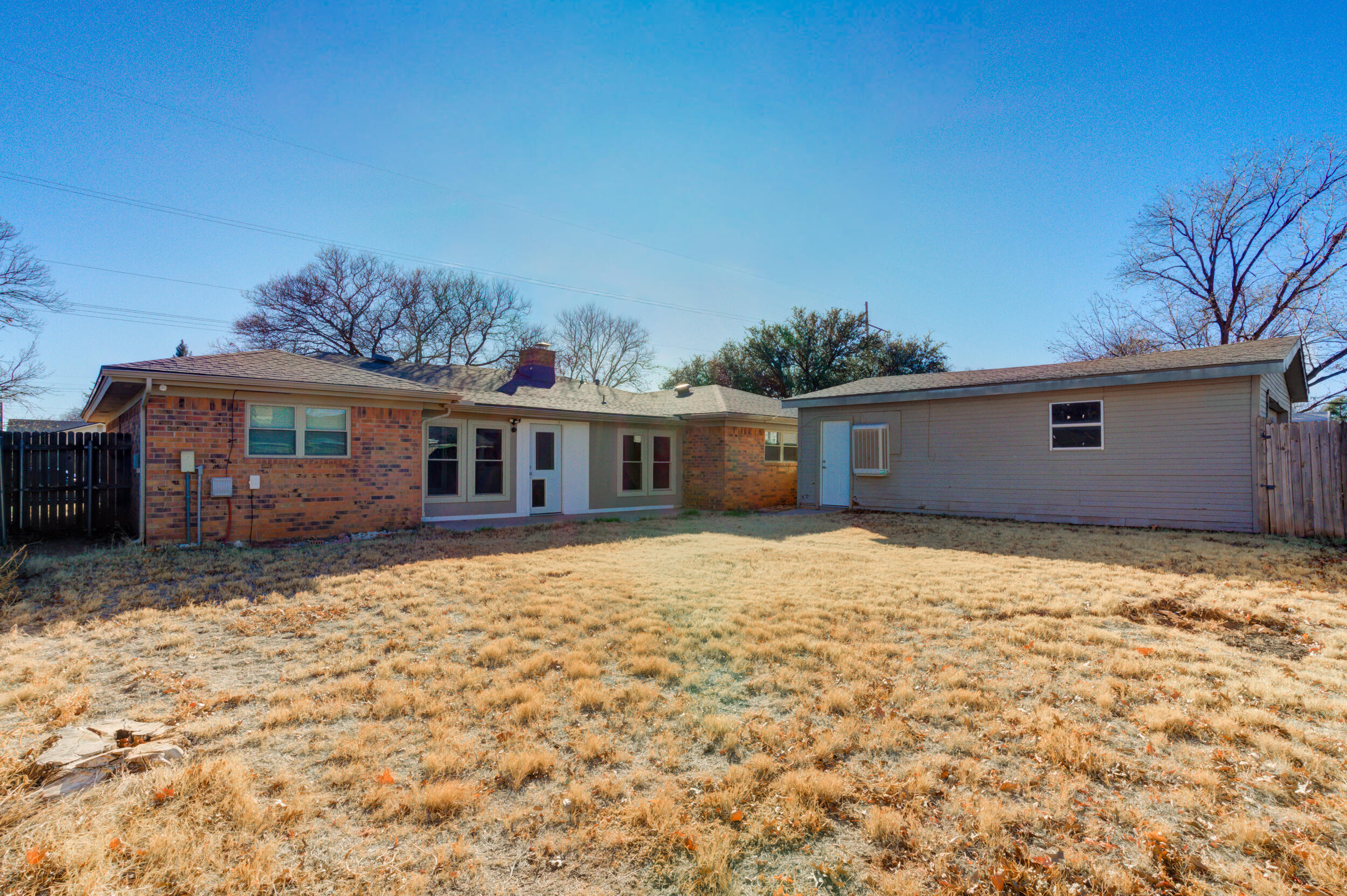 5504 73rd Street Lubbock, TX 79424 - Photo 35 of 39 a house with trees in the background