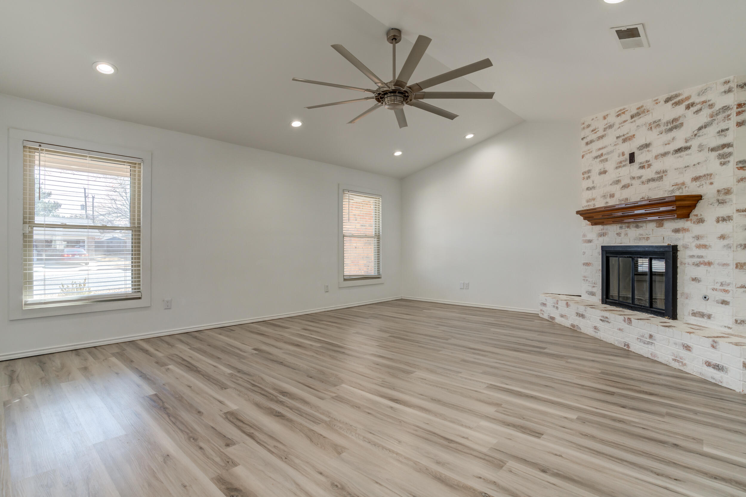 5504 73rd Street Lubbock, TX 79424 - Photo 6 of 39 a view of an empty room with wooden floor and a window