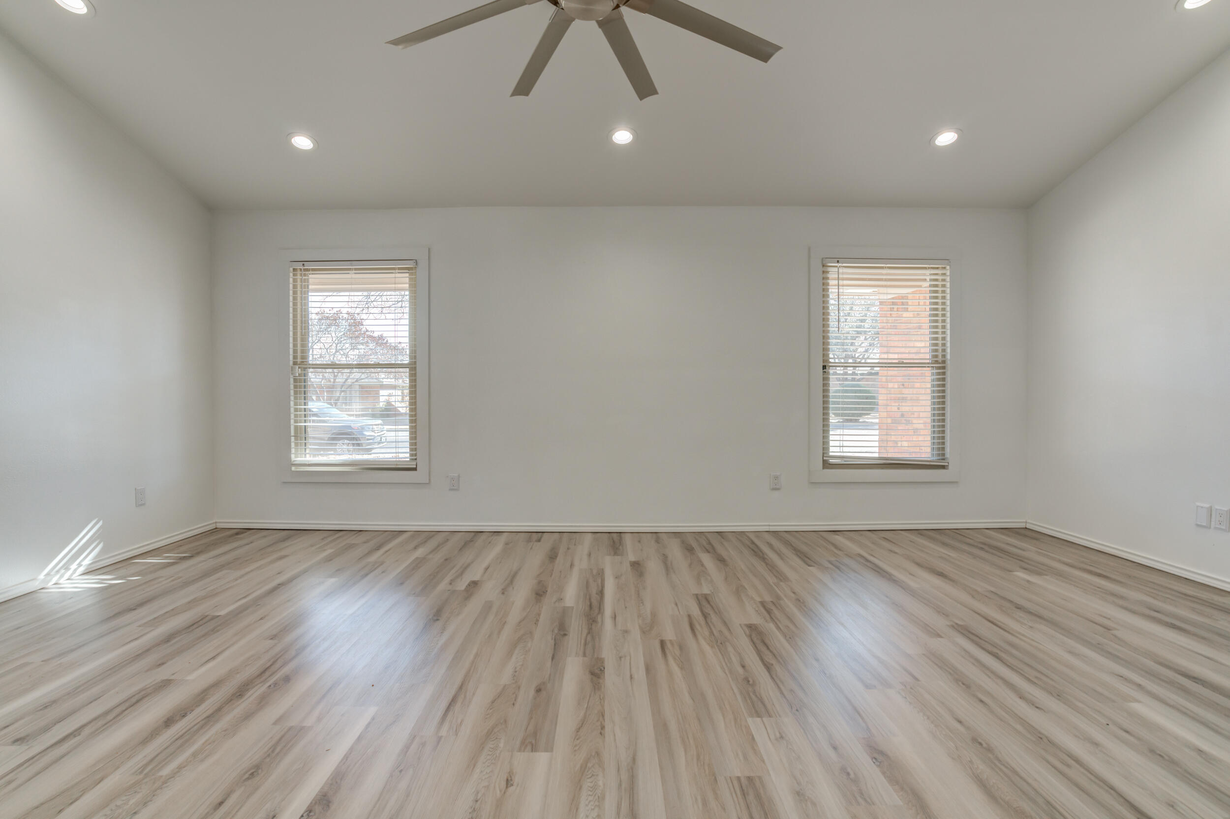 5504 73rd Street Lubbock, TX 79424 - Photo 7 of 39 an empty room with wooden floor and windows