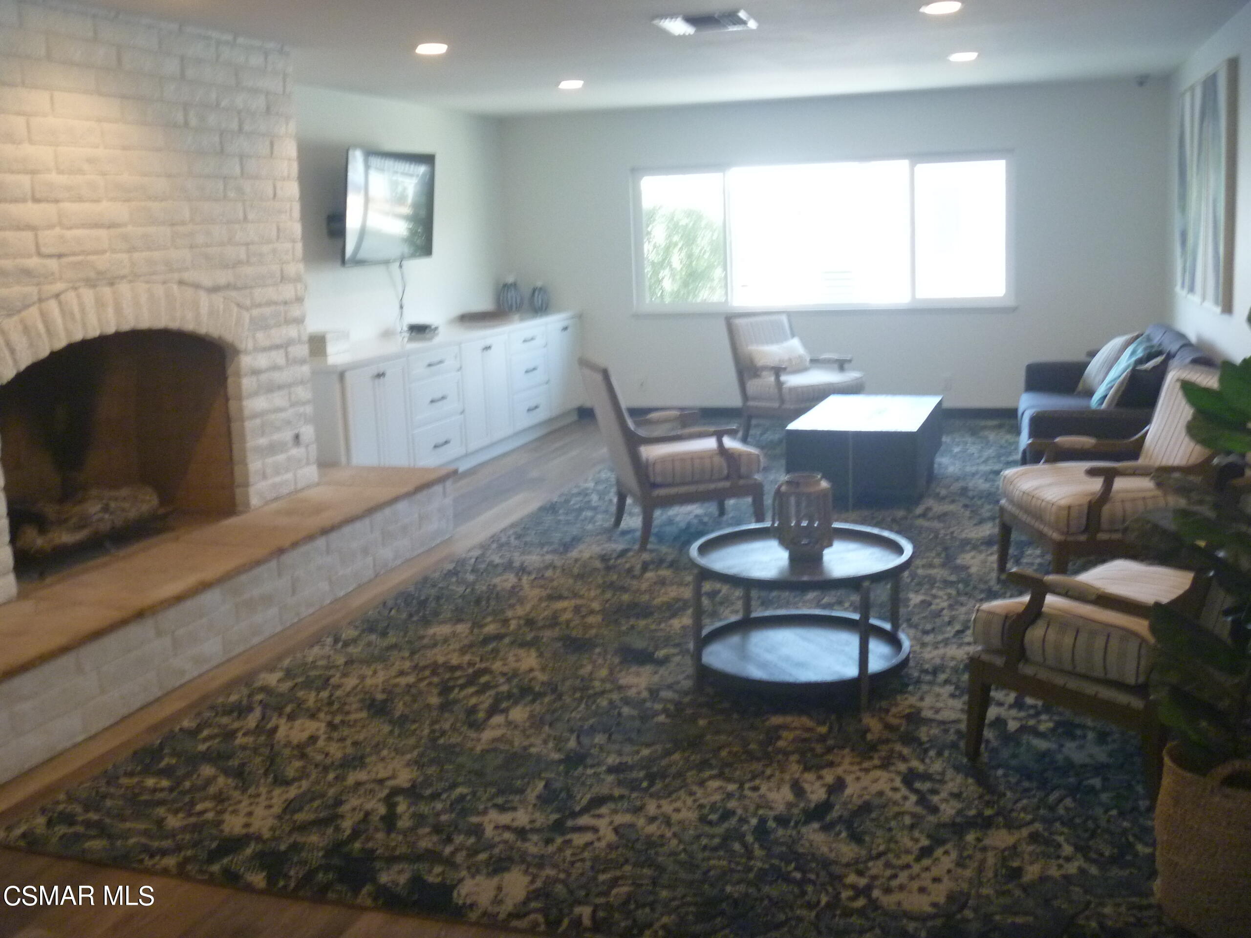250 East Telegraph Road, Unit 58 Fillmore, CA 93015 - Photo 26 of 29 a living room with furniture a fireplace and a flat screen tv