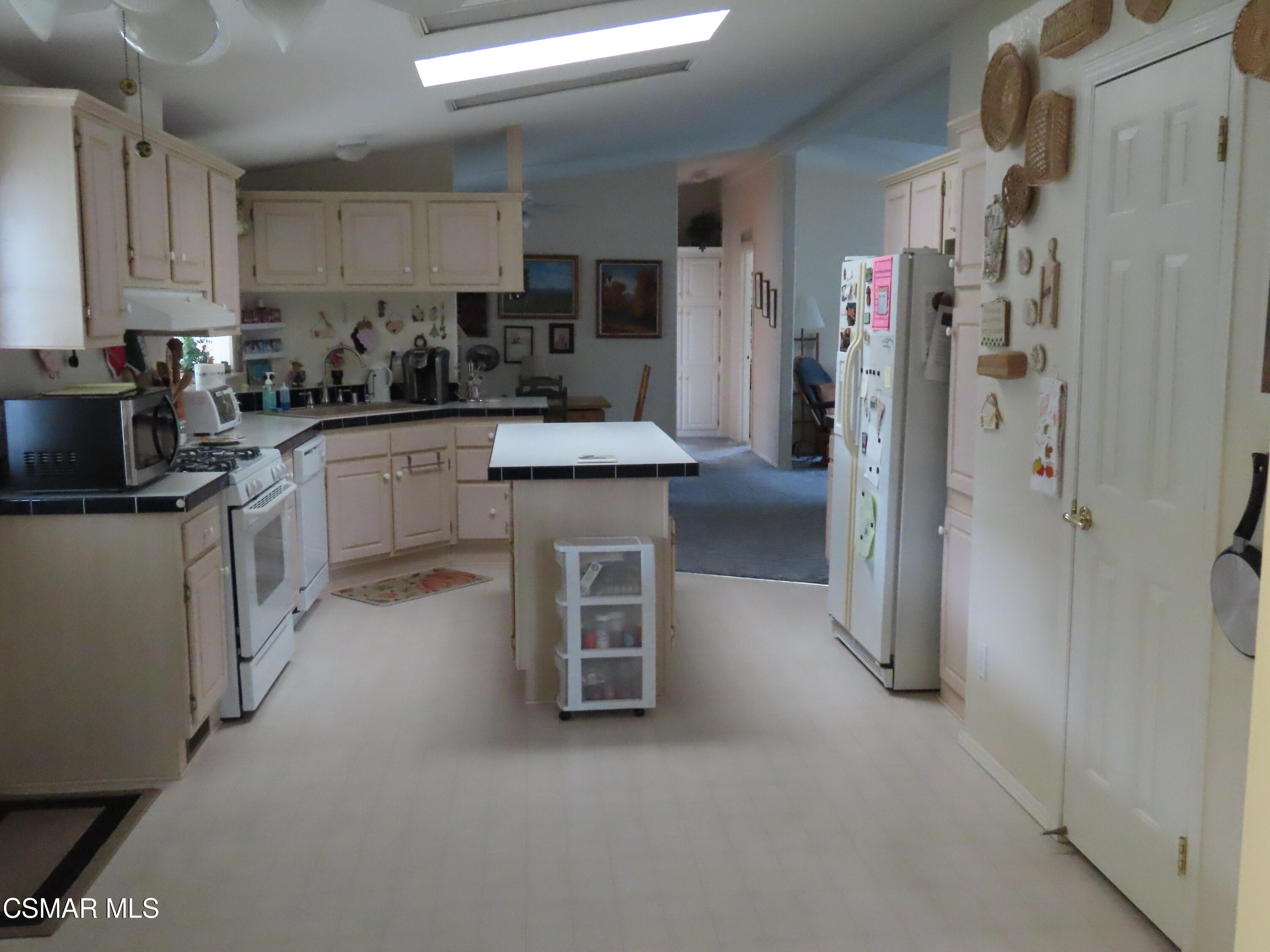 250 East Telegraph Road, Unit 58 Fillmore, CA 93015 - Photo 3 of 29 a kitchen with refrigerator and cabinets
