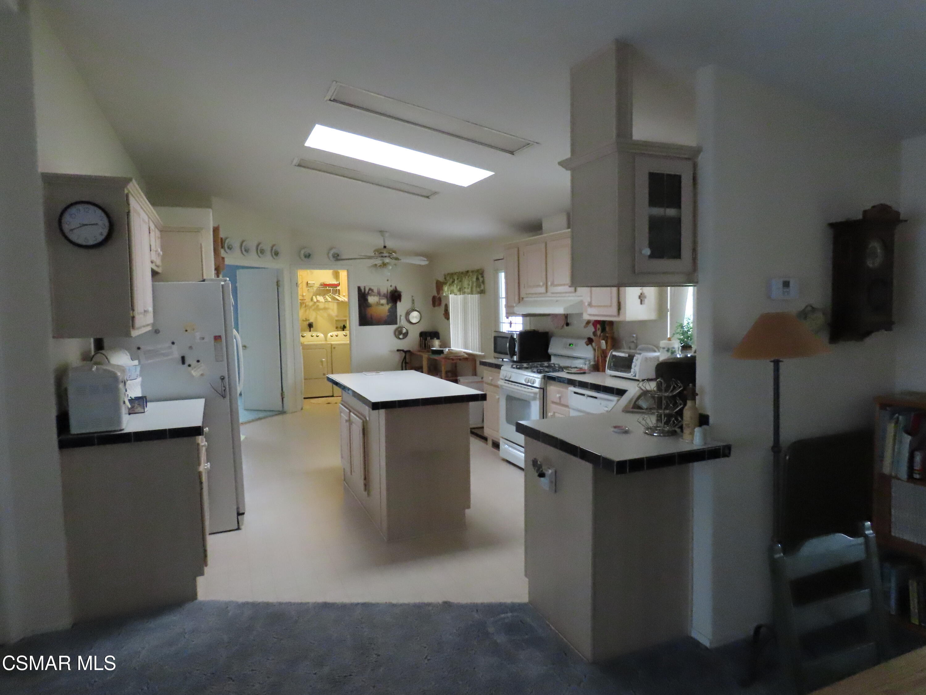 250 East Telegraph Road, Unit 58 Fillmore, CA 93015 - Photo 4 of 29 a kitchen with sink stove and cabinets