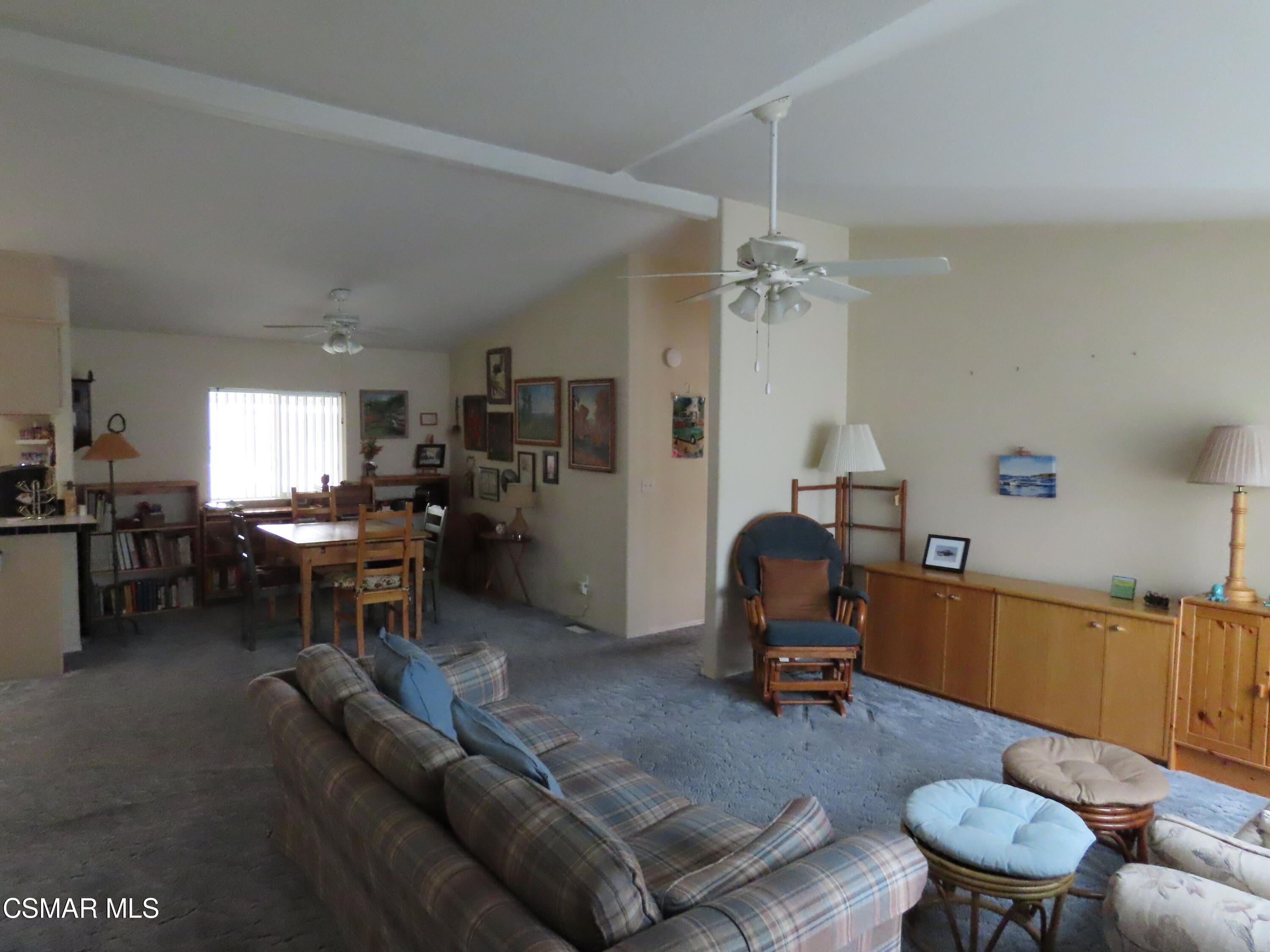 250 East Telegraph Road, Unit 58 Fillmore, CA 93015 - Photo 7 of 29 a living room with furniture a wooden floor and a chandelier