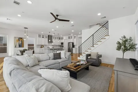 a living room with furniture and wooden floor