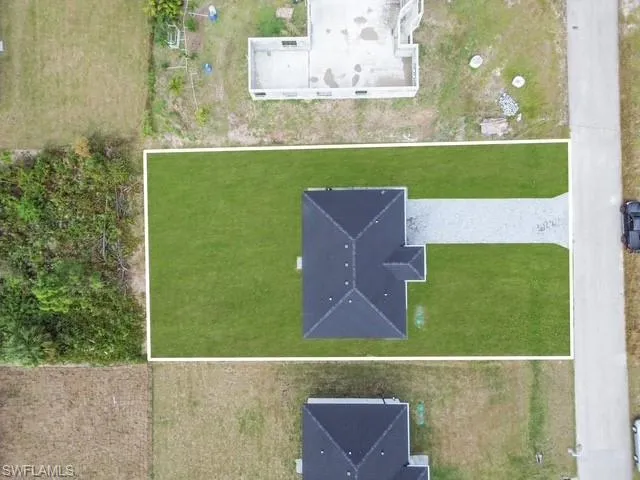 an aerial view of a house with a yard