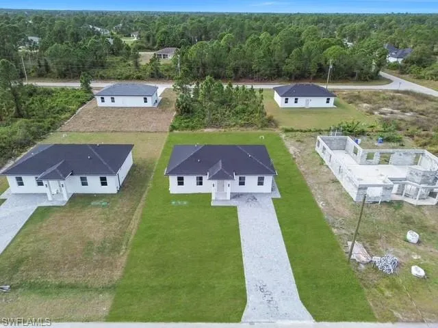 an aerial view of a house with garden space and street view