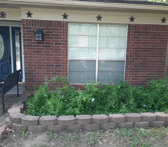 a brick building with a yard